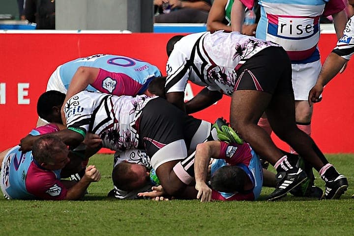 Kids playing rugby on field